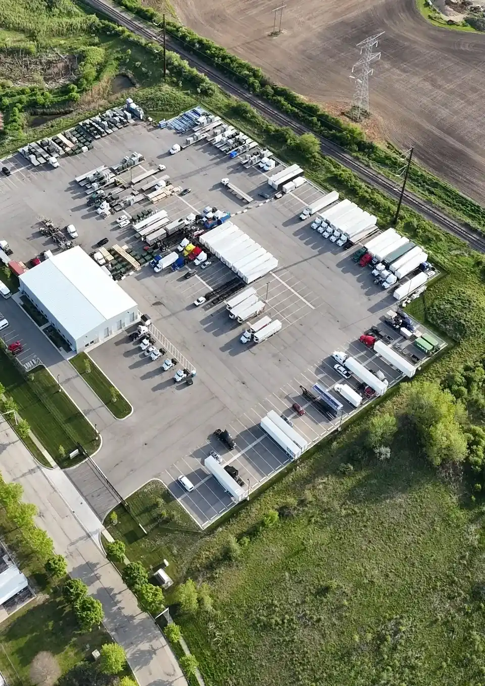 Aerial daytime view of fleet trucks parked in rows at Zion Truck Parking
